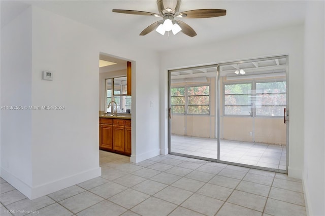 spare room featuring light tile patterned flooring, sink, and ceiling fan