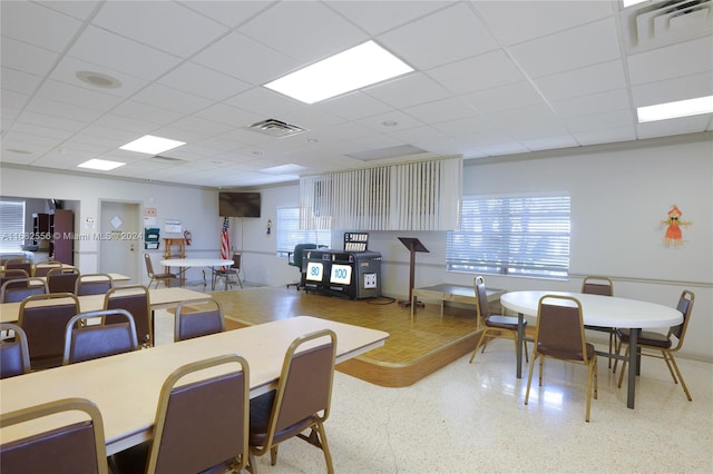 dining space featuring a drop ceiling