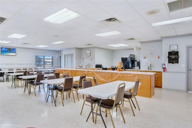 dining space featuring a drop ceiling