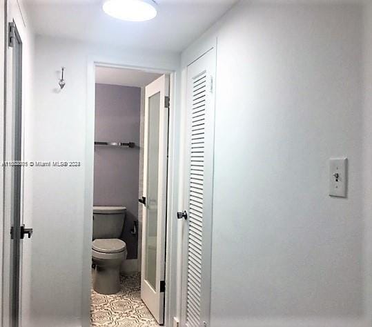 bathroom featuring toilet and tile patterned flooring