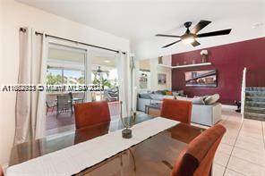 tiled dining area with ceiling fan