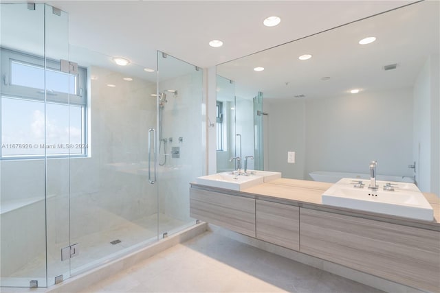 bathroom featuring vanity and a shower with shower door