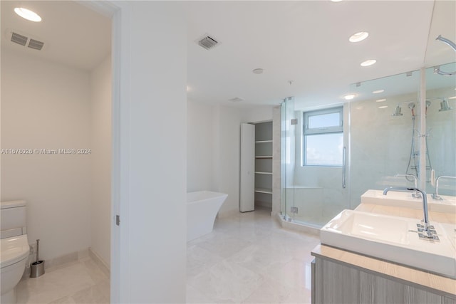 full bathroom featuring toilet, vanity, and separate shower and tub