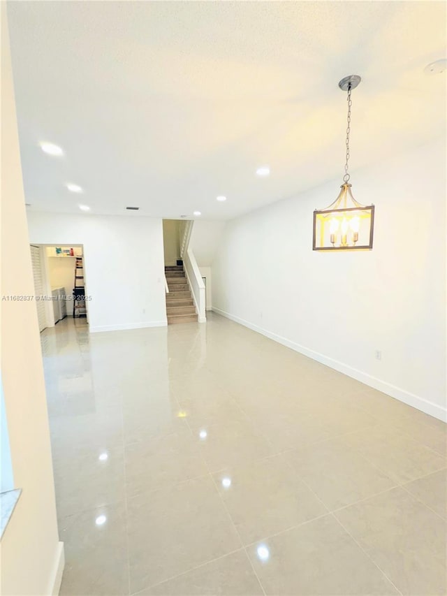 spare room featuring light tile patterned floors, baseboards, recessed lighting, and stairs