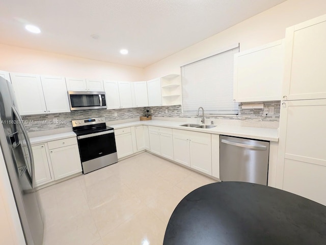 kitchen featuring light tile patterned flooring, sink, white cabinetry, and stainless steel appliances