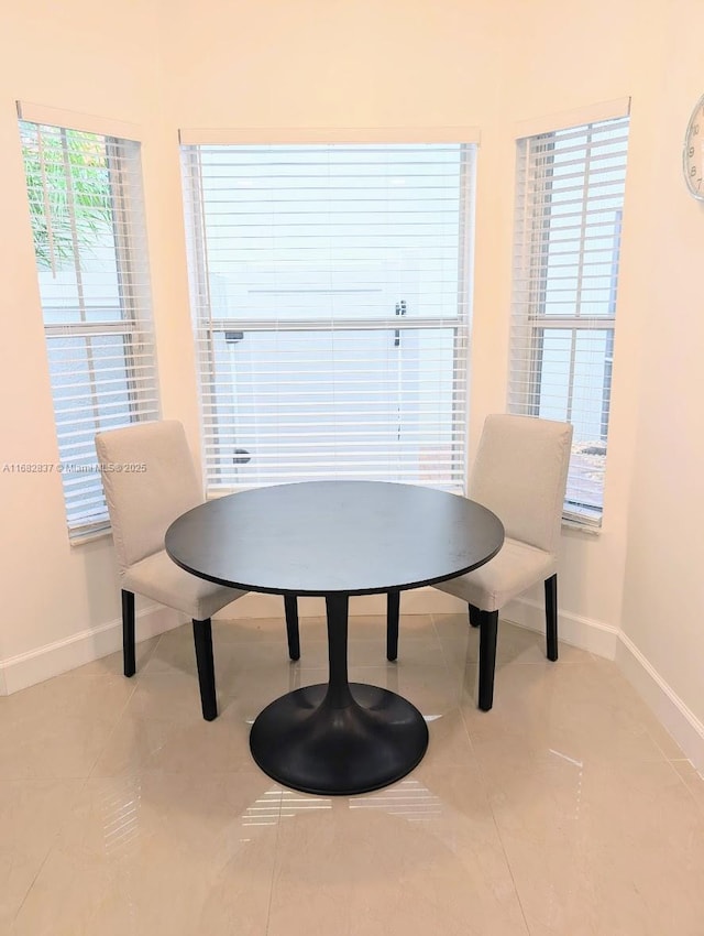 dining area with light tile patterned floors