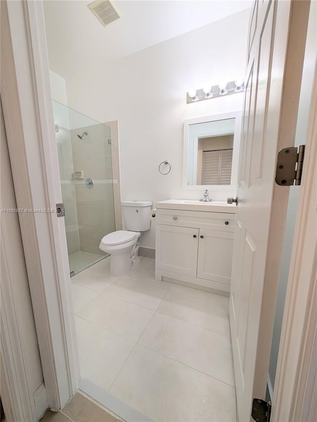 bathroom with vanity, visible vents, a shower stall, tile patterned floors, and toilet