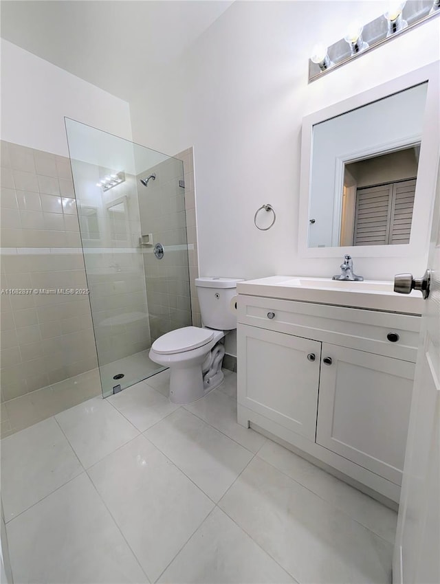 full bathroom featuring tile patterned floors, toilet, a walk in shower, and vanity