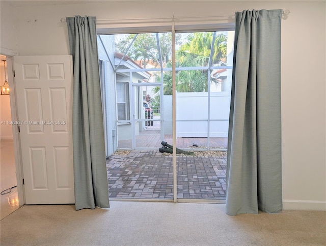 doorway to outside featuring carpet