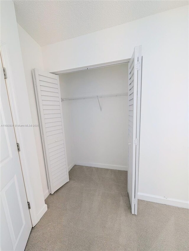 doorway featuring light colored carpet