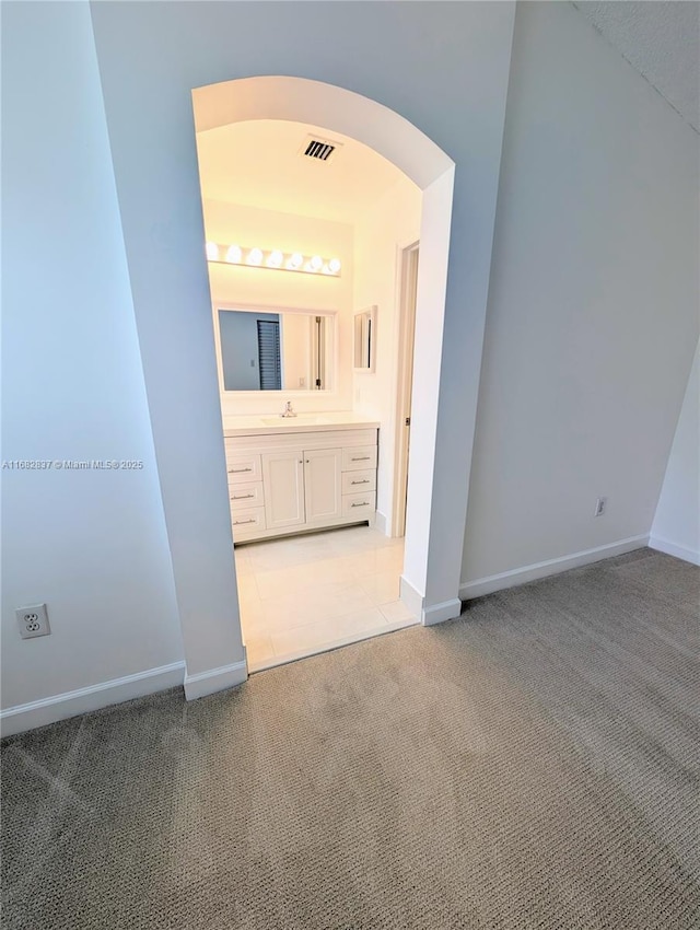 interior space with visible vents, baseboards, and vanity