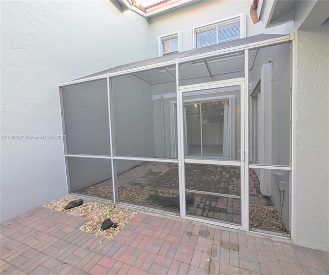 property entrance with stucco siding