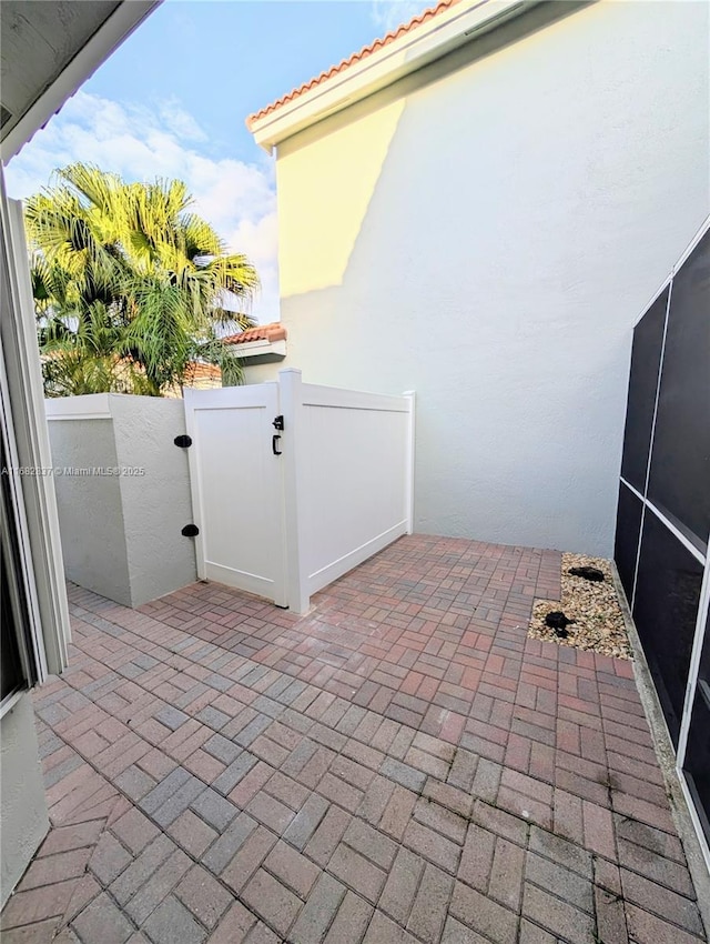 view of patio featuring a gate and fence