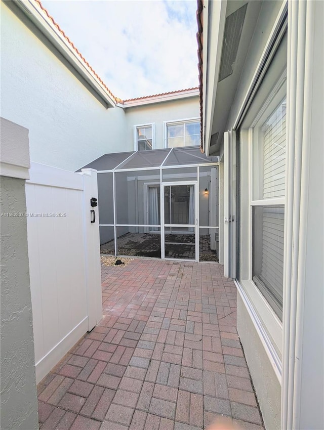 view of patio / terrace featuring a lanai