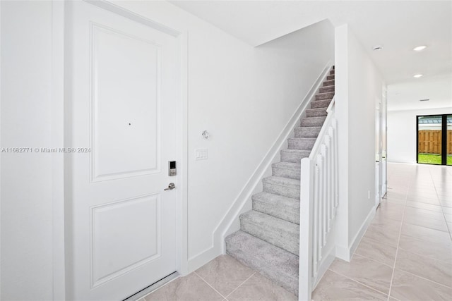 stairway with tile patterned flooring