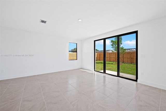 unfurnished room featuring light tile patterned floors