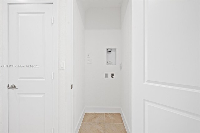 laundry room with electric dryer hookup, washer hookup, and light tile patterned floors