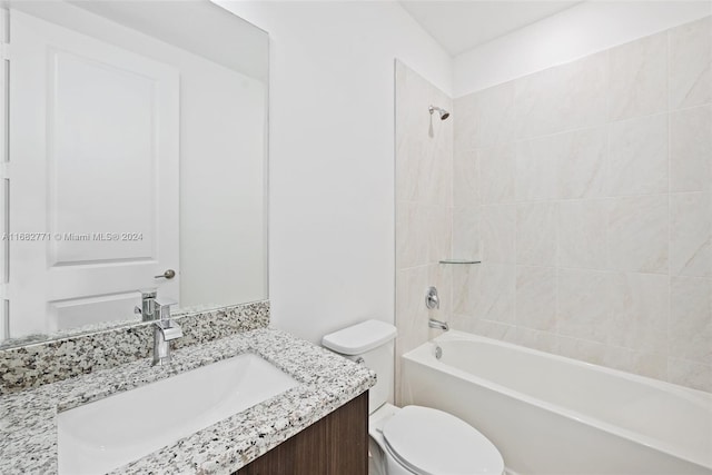 full bathroom with vanity, tiled shower / bath combo, and toilet