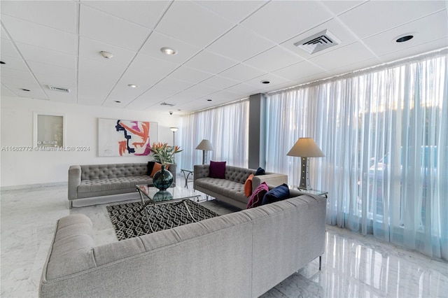 living room with a paneled ceiling