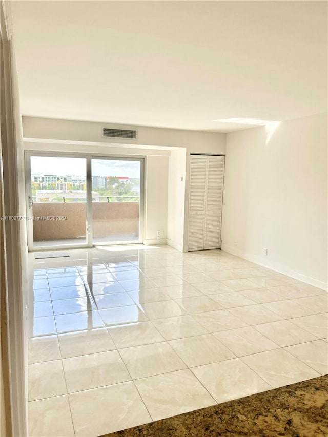 empty room with light tile patterned floors