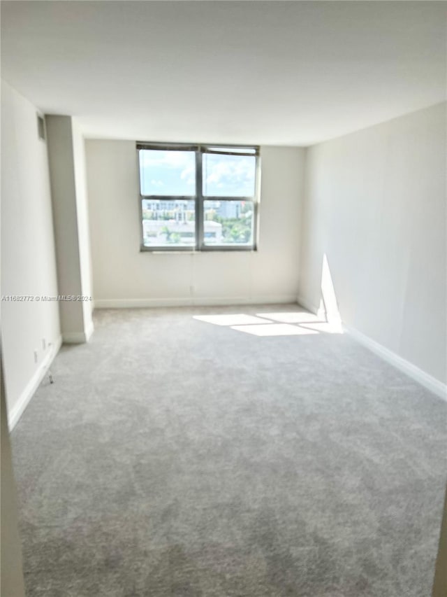 spare room featuring carpet