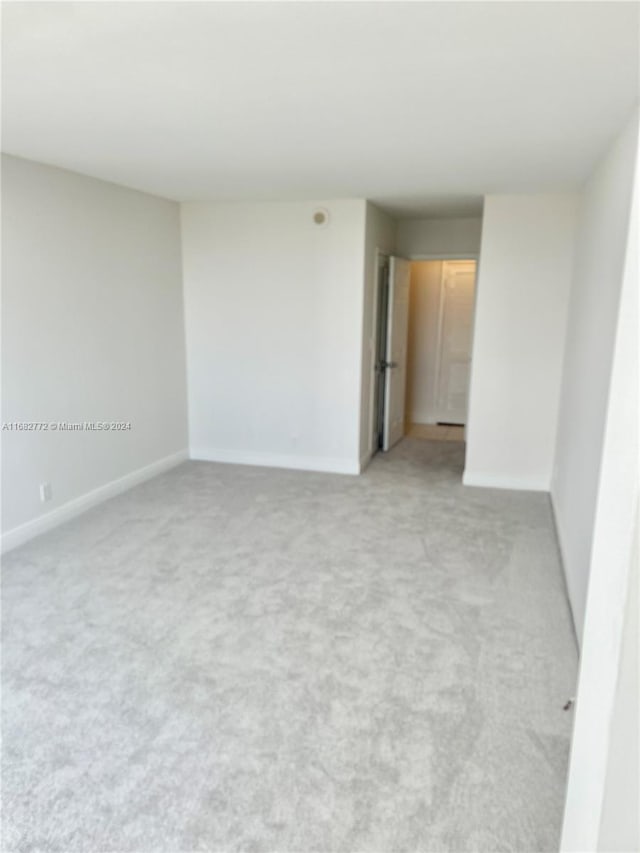 empty room featuring light colored carpet