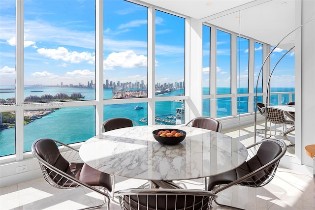 sunroom / solarium with a water view