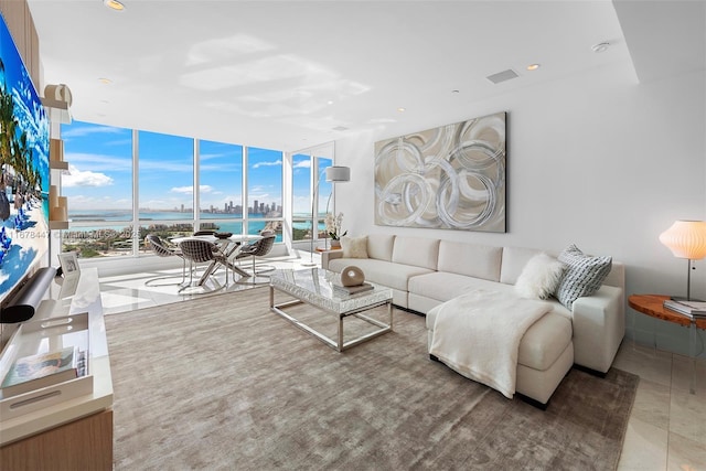 living room with expansive windows and a water view