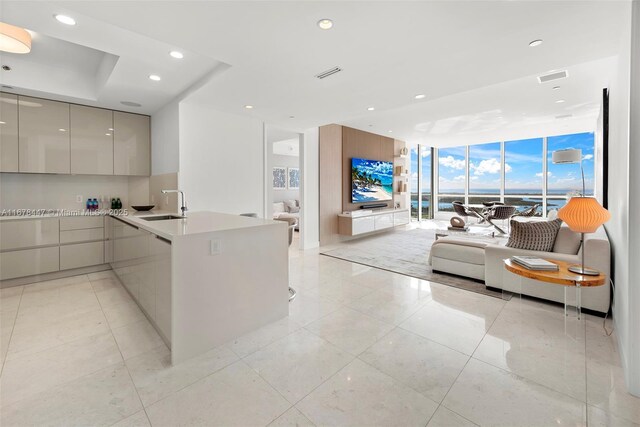 tiled bedroom with ceiling fan, expansive windows, and a water view