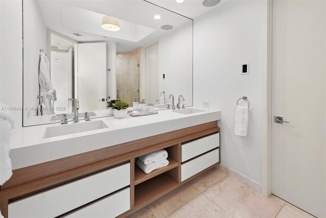 bathroom featuring tile patterned flooring, vanity, and an enclosed shower