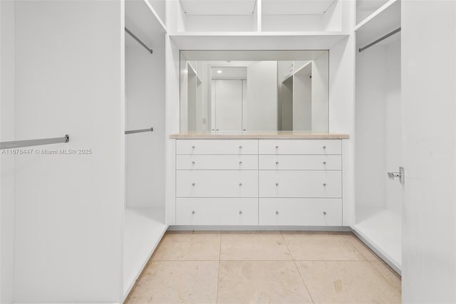 spacious closet with light tile patterned floors