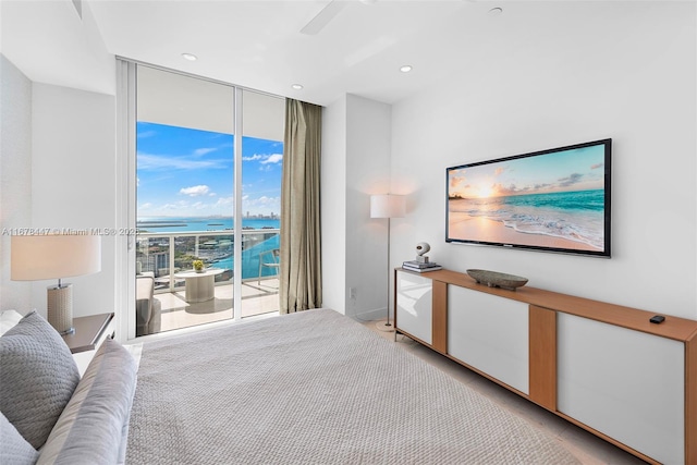 bedroom with access to outside, floor to ceiling windows, and ceiling fan