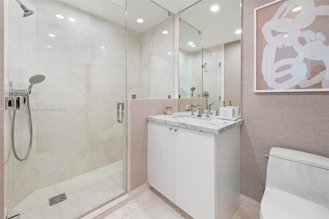 bathroom featuring vanity, tile patterned flooring, toilet, walk in shower, and tile walls