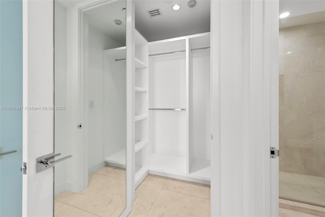 spacious closet featuring light tile patterned floors