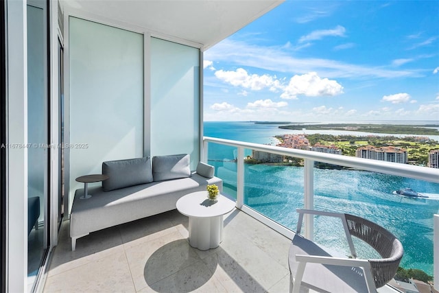 balcony with outdoor lounge area and a water view