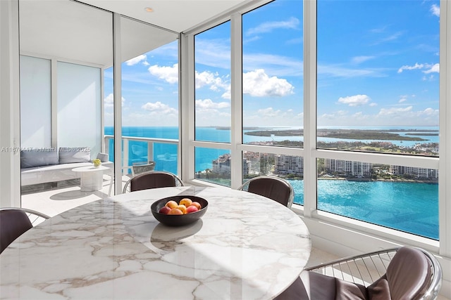 sunroom / solarium featuring a water view