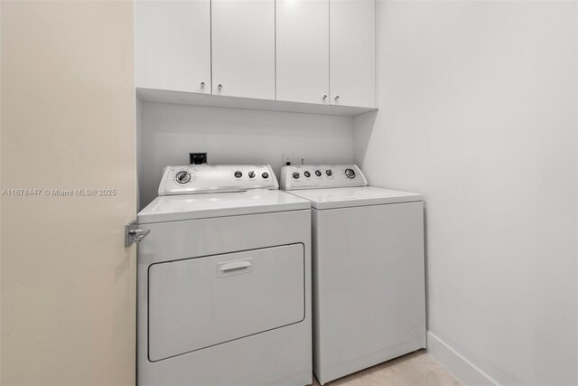 laundry area with cabinets and washing machine and dryer