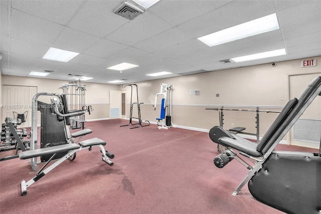 workout area with a drop ceiling and carpet floors