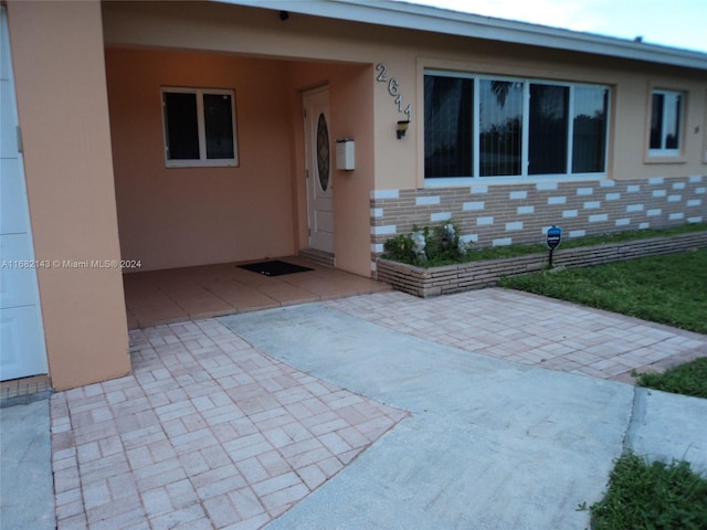 property entrance featuring a patio