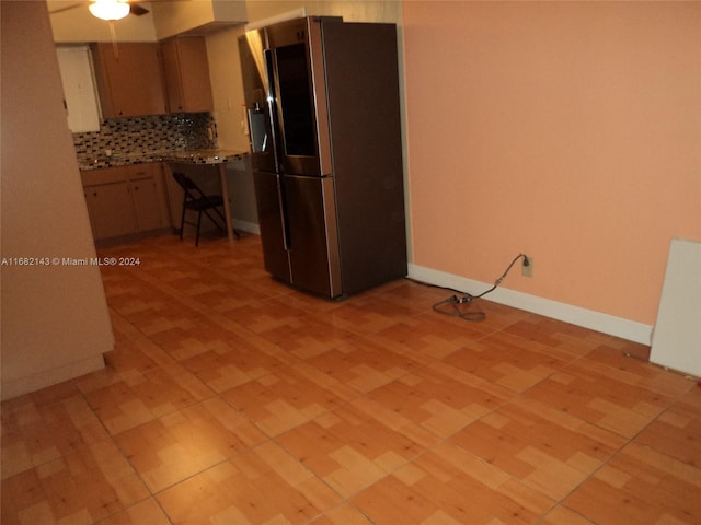 kitchen with ceiling fan, decorative backsplash, and stainless steel refrigerator with ice dispenser