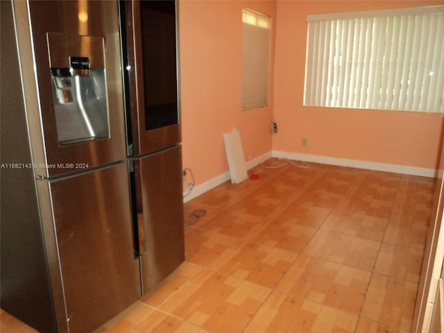 kitchen featuring light hardwood / wood-style floors and stainless steel fridge with ice dispenser