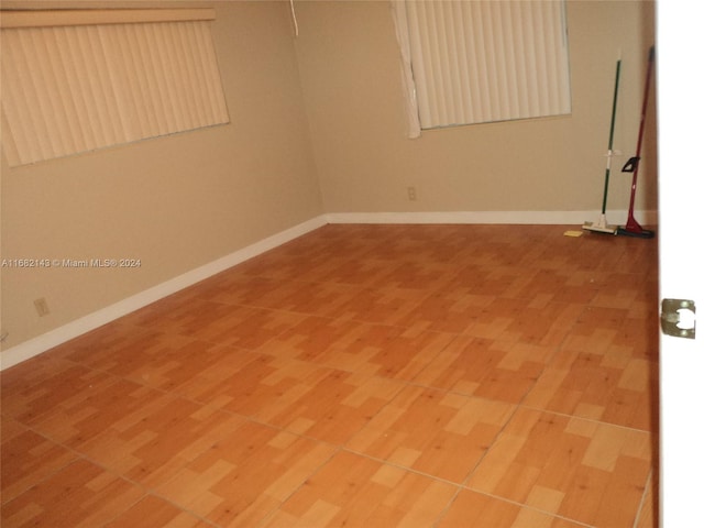 empty room with hardwood / wood-style flooring