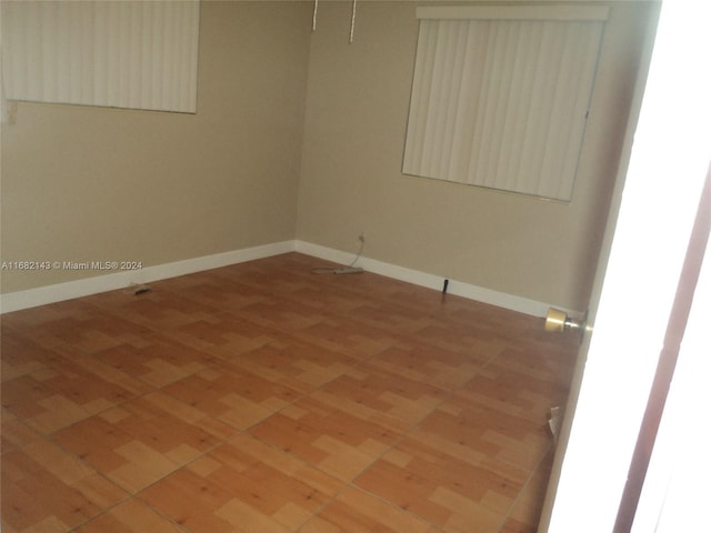 empty room with hardwood / wood-style floors