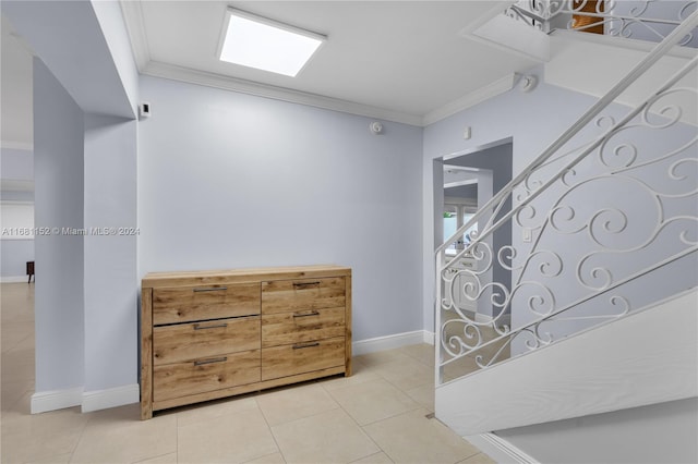 interior space featuring crown molding and light tile patterned floors