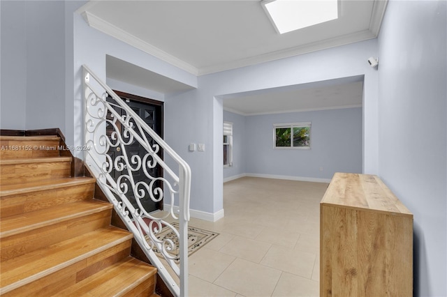 staircase featuring crown molding and tile patterned floors