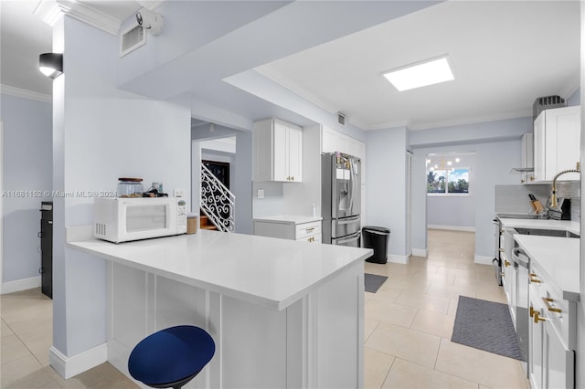 kitchen featuring tasteful backsplash, kitchen peninsula, white cabinets, ornamental molding, and stainless steel refrigerator with ice dispenser