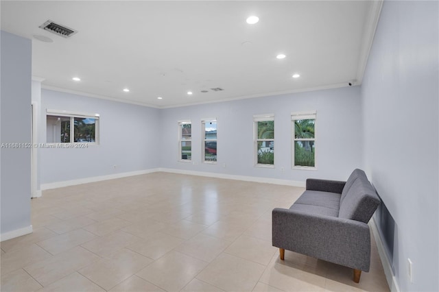 living area featuring crown molding and light tile patterned flooring