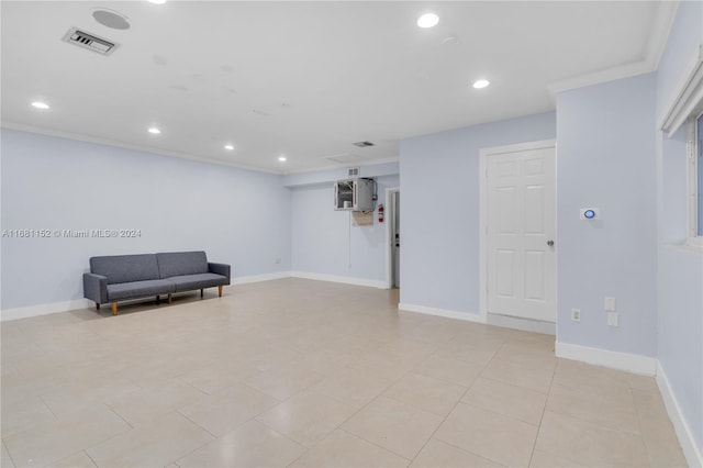 living area featuring ornamental molding and light tile patterned floors