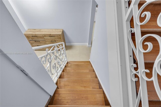 stairway with hardwood / wood-style floors