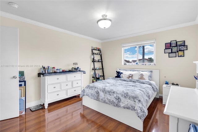 bedroom with ornamental molding and dark hardwood / wood-style floors